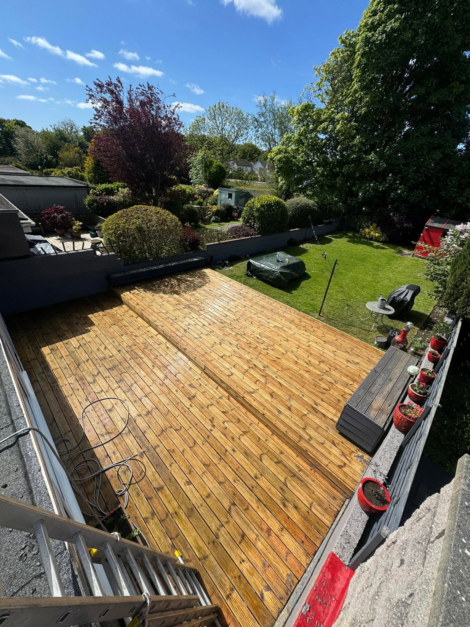 Restored golden timber garden decking after cleaning