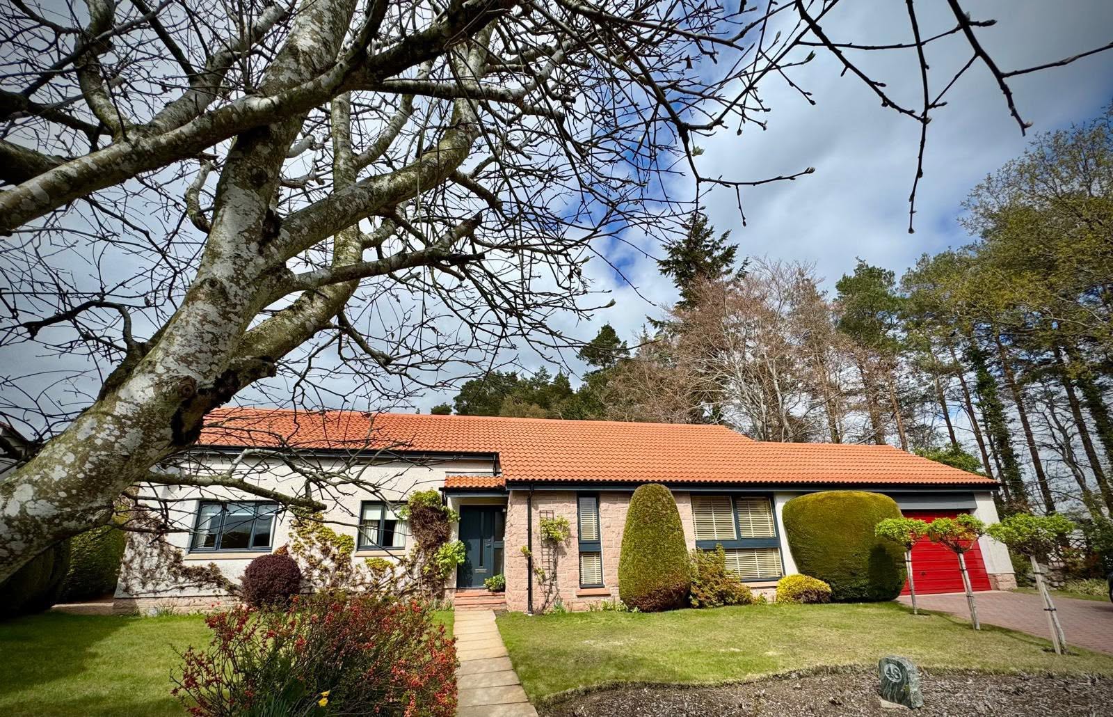 Bungalow with freshly cleaned red tiled roof