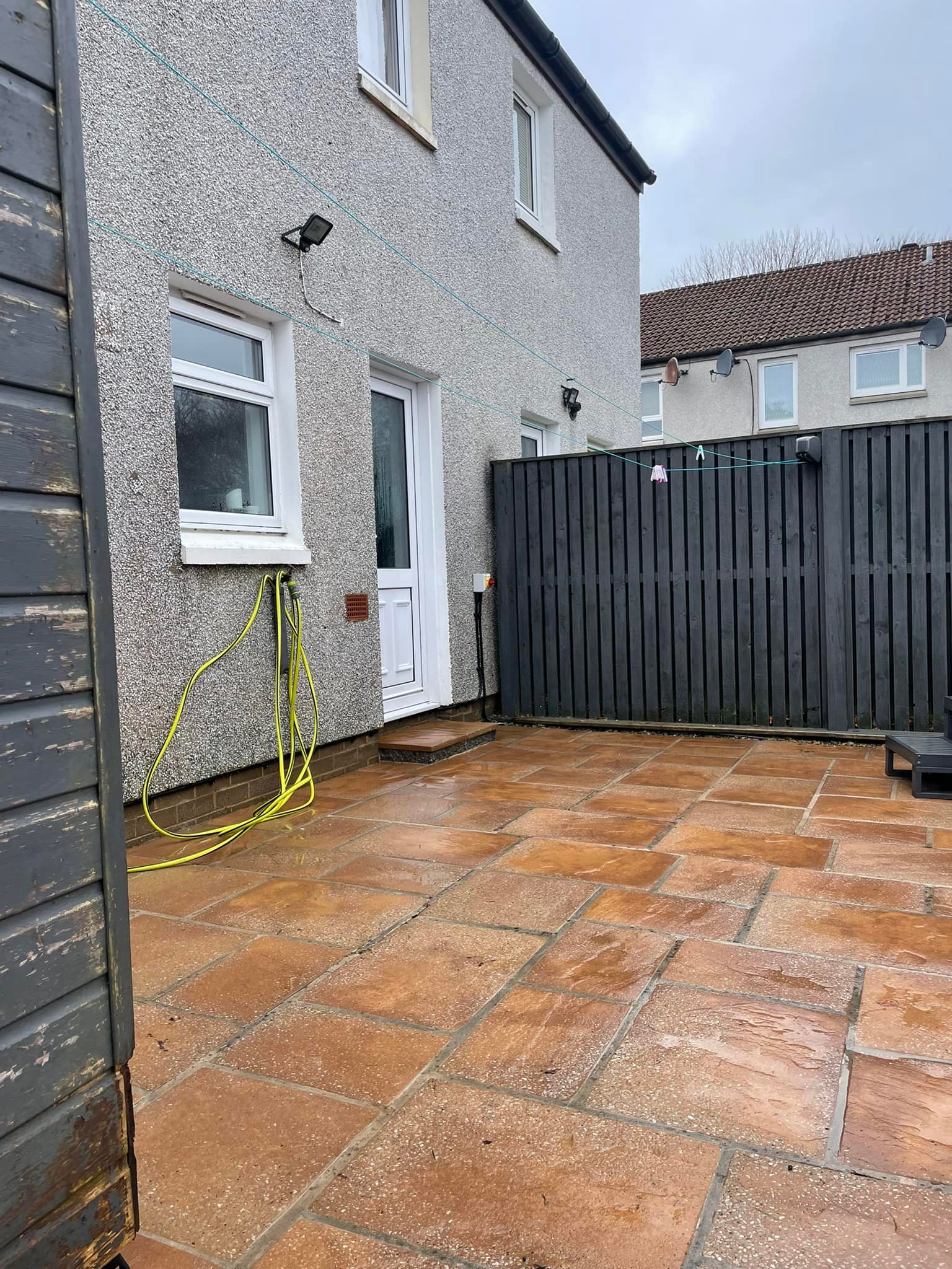 Aberdeen rear patio after pressure washing, slabs clean and warm-toned