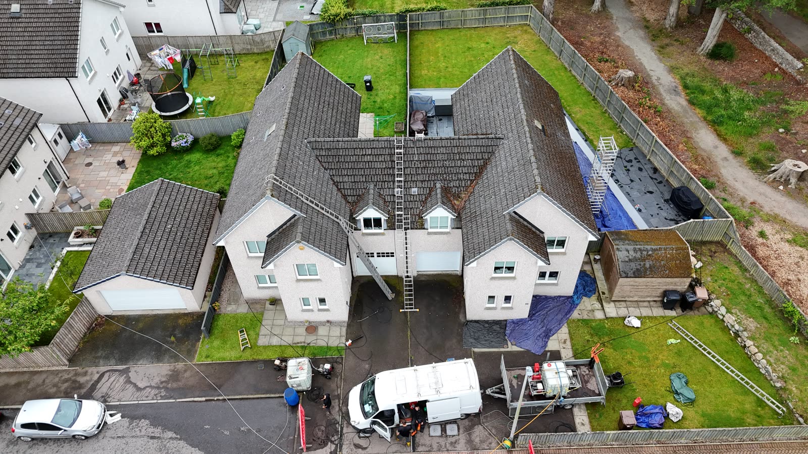 The same roofs before cleaning, dark with moss